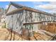 Back view of townhome with fenced yard, concrete patio, and green space at 495 Duval Dr, Alpharetta, GA 30009