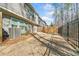 Back view of townhome with fenced yard, concrete patio, and green space at 495 Duval Dr, Alpharetta, GA 30009