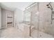 Bright bathroom with glass shower and tub next to a window, showcasing neutral tile flooring and walls at 495 Duval Dr, Alpharetta, GA 30009