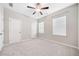 Bedroom with neutral colored carpet, white walls, a ceiling fan and two windows with closed blinds at 495 Duval Dr, Alpharetta, GA 30009