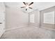 Bright bedroom with neutral colored carpet, white walls, and two windows with closed blinds at 495 Duval Dr, Alpharetta, GA 30009