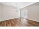 Bright dining area features wood flooring, modern chandelier and sliding glass doors at 495 Duval Dr, Alpharetta, GA 30009
