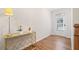 Bright entryway featuring a decorative gold console table, modern flooring, and a glass-paneled front door at 495 Duval Dr, Alpharetta, GA 30009