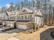 Attractive townhouse with a two-car garage, brick driveway, and well-manicured landscaping at 495 Duval Dr, Alpharetta, GA 30009