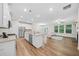 Open concept kitchen with stainless steel appliances, a kitchen island, and a connected living area at 495 Duval Dr, Alpharetta, GA 30009