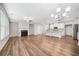 Open floor plan living room with modern fireplace, hardwood flooring, and updated kitchen at 495 Duval Dr, Alpharetta, GA 30009