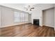 Cozy living room with a fireplace, ceiling fan and large windows allowing for ample natural light at 495 Duval Dr, Alpharetta, GA 30009