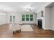 Cozy living room featuring neutral walls, modern flooring, fireplace, and large windows with natural light at 495 Duval Dr, Alpharetta, GA 30009