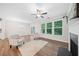 Bright living room showcasing modern flooring, fireplace, large windows, and contemporary neutral furniture at 495 Duval Dr, Alpharetta, GA 30009