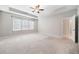 Spacious primary bedroom with carpet, a tray ceiling, ceiling fan and large windows at 495 Duval Dr, Alpharetta, GA 30009