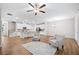 Open-concept kitchen and living room with stainless steel appliances, modern seating, and wood-look floors at 495 Duval Dr, Alpharetta, GA 30009