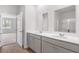 Modern bathroom with double vanity sinks, bright lighting, and a view of the bedroom at 6123 Knickerbocker St, Mableton, GA 30127