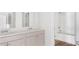 Elegant bathroom with double sinks, modern faucets, and a shower-tub combination with stylish fixtures at 6123 Knickerbocker St, Mableton, GA 30127