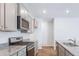 Stylish kitchen showcasing stainless steel appliances, granite countertops, and ample storage space in modern cabinetry at 6123 Knickerbocker St, Mableton, GA 30127