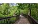 Picturesque wooden bridge winding through lush greenery, inviting residents to explore scenic trails at 6123 Knickerbocker St, Mableton, GA 30127