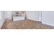 Open concept living room with a view of the modern kitchen, hardwood floors, and natural light at 6123 Knickerbocker St, Mableton, GA 30127
