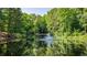 Scenic community pond featuring a tranquil fountain, enhancing the serene atmosphere of the community at 6123 Knickerbocker St, Mableton, GA 30127