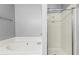 Well-lit bathroom featuring soaking tub and glass shower at 1332 Adcox Sq, Stone Mountain, GA 30088