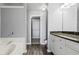 Bright bathroom featuring wood floors, granite countertop, and built in cabinets at 1332 Adcox Sq, Stone Mountain, GA 30088