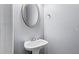 Bathroom with a modern sink, oval mirror, and a minimalist design at 1332 Adcox Sq, Stone Mountain, GA 30088