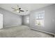 Large bedroom with two windows, ceiling fan, and neutral carpeting at 1332 Adcox Sq, Stone Mountain, GA 30088