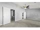 A bright bedroom with neutral carpeting featuring three doorways at 1332 Adcox Sq, Stone Mountain, GA 30088