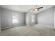 Spacious bedroom with vaulted ceiling, two windows, ceiling fan, and neutral carpeting at 1332 Adcox Sq, Stone Mountain, GA 30088