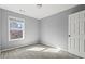 Cozy bedroom featuring soft carpet, a window, and simple design at 1332 Adcox Sq, Stone Mountain, GA 30088
