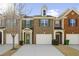 Charming brick townhome featuring a one-car garage and well-maintained landscaping at 1332 Adcox Sq, Stone Mountain, GA 30088