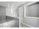 View of a bright hallway featuring gray walls, white doors, and neutral carpeting at 1332 Adcox Sq, Stone Mountain, GA 30088