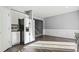 Modern kitchen with a stainless steel refrigerator, granite countertops, and staircase access at 1332 Adcox Sq, Stone Mountain, GA 30088