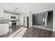Modern kitchen boasts stainless steel appliances, white cabinetry, and stylish wood flooring at 1332 Adcox Sq, Stone Mountain, GA 30088