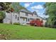 The home's exterior features a spacious backyard with a deck, lush lawn, and mature trees providing privacy and a shed at 283 Heron Lake Ct, Lawrenceville, GA 30043