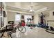Basement with ample workout area featuring a ceiling fan, tiled floor and fitness equipment at 283 Heron Lake Ct, Lawrenceville, GA 30043