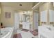 Bright and spacious bathroom features a soaking tub, separate vanities and access to the shower at 283 Heron Lake Ct, Lawrenceville, GA 30043