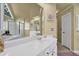 Bright bathroom with a soaking tub, walk-in shower, and white vanity with countertop space at 283 Heron Lake Ct, Lawrenceville, GA 30043