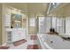 Bright bathroom featuring a soaking tub, shower, white vanity with ample counter space, and natural light at 283 Heron Lake Ct, Lawrenceville, GA 30043