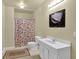 Clean bathroom features a shower with curtain, white toilet, and simple vanity at 283 Heron Lake Ct, Lawrenceville, GA 30043