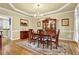 Elegant dining room with a chandelier, wood table, and decorative rug on hardwood floors at 283 Heron Lake Ct, Lawrenceville, GA 30043