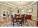 Formal dining room with a chandelier, wood floors, and an ornate wood table at 283 Heron Lake Ct, Lawrenceville, GA 30043