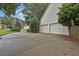 Long driveway leading to a three-car garage, offering plenty of parking space and curb appeal at 283 Heron Lake Ct, Lawrenceville, GA 30043
