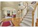 Spacious foyer featuring hardwood floors, staircase, and views into the living room at 283 Heron Lake Ct, Lawrenceville, GA 30043
