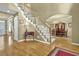 Grand foyer with hardwood floors, staircase, and view of the dining room at 283 Heron Lake Ct, Lawrenceville, GA 30043
