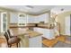 Charming kitchen with breakfast bar, granite countertops, and white cabinetry at 283 Heron Lake Ct, Lawrenceville, GA 30043
