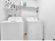 Convenient laundry room featuring a washing machine and dryer at 283 Heron Lake Ct, Lawrenceville, GA 30043