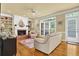 Comfortable living room with a fireplace, built-in shelves, and bright window at 283 Heron Lake Ct, Lawrenceville, GA 30043