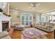 Inviting living room with hardwood floors, fireplace, and a large window to a covered patio at 283 Heron Lake Ct, Lawrenceville, GA 30043