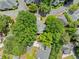 Aerial view of a home nestled among lush trees, showcasing the surrounding neighborhood and landscaping at 4411 Paces Battle Nw, Atlanta, GA 30327
