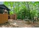 Relaxing backyard with brick pathway, fire pit, seating, and lush greenery, ideal for outdoor gatherings at 4411 Paces Battle Nw, Atlanta, GA 30327