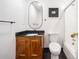 Bathroom featuring wood vanity with black countertop and white tile at 4411 Paces Battle Nw, Atlanta, GA 30327